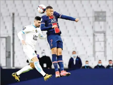  ?? NICOLAS TUCAT/AFP ?? Marseille’s defender Alvaro Gonzalez (left) heads the ball with Paris Saint-Germain’s forward Kylian Mbappe during the French L1 football match at the Velodrome Stadium in Marseille on Sunday.