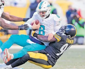  ?? CHARLES TRAINOR JR./TNS ?? Steelers LB Lawrence Timmons, right, sacks Dolphins QB Matt Moore during an AFC Wild Card game in January in Pittsburgh. Miami signed Timmons (114 tackles, 2.5 sacks in 2016) to a 2-year deal and is hoping he’ll help bolster its defense.