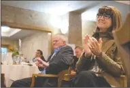  ??  ?? Above left: Lodi City Councilman Mark Chandler bows his head during the invocation prayer at the Mayor’s State of the City breakfast. Above right: Visit Lodi! President and CEO Nancy Beckman applauds during the breakfast.