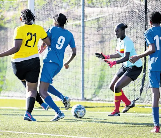  ?? RICARDO MAKYN/CHIEF PHOTO EDITOR ?? Cavalier’s Sashanna Watson (left) scores past goalkeeper Jonique McFarlane while under pressure from Proven Girls FC’s Keylee Edwards during last Saturday’s Jamaica Women’s Profession­al League match at the UWI-JFF Captain Horace Burrell Centre of Excellence. Cavalier won 12-0.