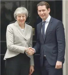  ?? — AFP ?? Britain’s Prime Minister Theresa May greets Austria’s Chancellor Sebastian Kurz outside of 10 Downing Street in central London on Thursday, ahead of their meeting.