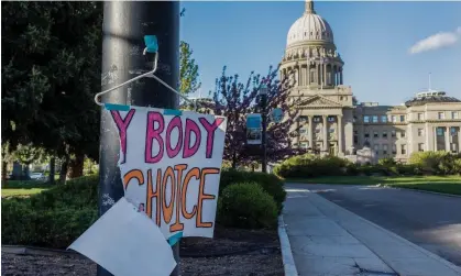  ?? Photograph: Sarah A Miller/AP ?? A sign reading ‘My body, my choice’ is taped to a hanger taped to a streetligh­t in front of the Idaho state capitol building in Boise.