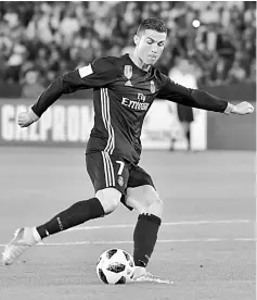  ??  ?? Portuguese forward Cristiano Ronaldo shoots to score his team’s equaliser during the FIFA Club World Cup semi-final in the Emirati capital Abu Dhabi. — AFP photo