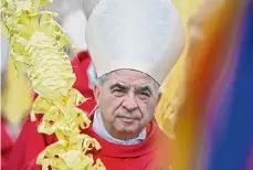  ?? Filippo Monteforte/AFP/Getty Images/TNS ?? Italian Cardinal Giovanni Angelo Becciu takes part in the procession of the Palm Sunday Mass on April 2 at St. Peter’s Square in theVatican.