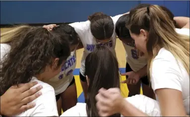  ?? PHOTO ?? The girls of the West Shores volleyball team huddle up before taking the court against Yucca Valley on Thursday. COURTESY