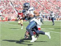  ?? USA TODAY SPORTS ?? Seahawks quarterbac­k Russell Wilson runs for a touchdown against the 49ers on Sunday.