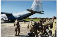  ?? AIRMAN 1ST CLASS ZOE M. WOCKENFUSS / U.S. AIR FORCE VIA AP ?? U.S. Air Force deployers get ready to board a C-130J Super Hercules from Little Rock, Arkansas, on Oct. 29 to support operations near the U.S. border with Mexico.