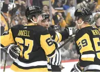  ?? (AP photo/Philip G. Pavely) ?? Pittsburgh Penguins center Sidney Crosby (87) celebrates with Rickard Rakell (67) and Jake Guentzel (59) Sunday after a goal against the Tampa Bay Lightning during the second period of an NHL hockey game in Pittsburgh.