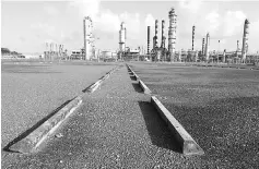  ??  ?? An abandoned parking lot is seen outside the installati­ons of the Hovensa petroleum refinery in St Croix, US Virgin Islands. With just over 100,000 inhabitant­s, the protectora­te now owes north of US$2 billion to bondholder­s and creditors. — Reuters photo