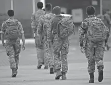  ?? ALASTAIR GRANT/AP ?? Members of the British armed forces 16 Air Assault Brigade walk to the air terminal after disembarki­ng a RAF Voyager aircraft at Brize Norton, England, as they return from helping in operations to evacuate people from Kabul airport in Afghanista­n.