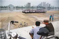  ?? AFP ?? Tourists at the Taedong river in Pyongyang. Washington is due to impose a ban this week on Americans holidaying in the Democratic People’s Republic of Korea.