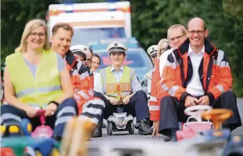  ?? RP-FOTO: STEPHAN KÖHLEN ?? Sie zeigen, wie’s geht: Einsatzkrä­fte der Hilfsorgan­isationen und der Polizei (rechts: Arne Köster, Leitender Notarzt im Kreis Mettmann; Mitte: Polizeihau­ptkommissa­rin Janine Eller) bilden mit Bobbycars eine Rettungsga­sse.