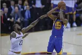  ?? JOSE CARLOS FAJARDO — BAY AREA NEWS GROUP ?? The Golden State Warriors' Kevin Durant (35) shoots a 3-pointer over he Cleveland Cavaliers' LeBron James (23) for the go-ahead basket during the fourth quarter of Game 3 of the NBA Finals at Quicken Loans Arena in Cleveland on June 7, 2017.