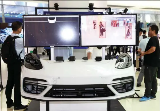  ?? ZHANG HENGWEI / CHINA NEWS SERVICE ?? An AI-enabled system to identify pedestrian­s is displayed at the World Intelligen­t Connected Vehicles Conference in Shanghai.