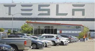  ?? BEN MARGOT AP FILE ?? Tesla production workers, material handlers and quality inspectors will get a “market adjustment” pay raise, according to Bloomberg News, which reported the raises early Thursday.
