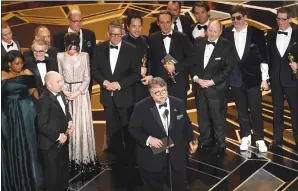  ?? Associated Press photos ?? Guillermo del Toro and the cast and crew of “The Shape of Water” accept the award for best picture at the Oscars on Sunday at the Dolby Theatre in Los Angeles.