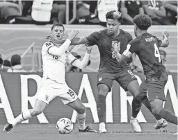  ?? YUKIHITO TAGUCHI/USA TODAY SPORTS ?? United States midfielder Weston McKennie (8) fouls England midfielder Mason Mount (19) during the first half Friday in Al Khor, Qatar.