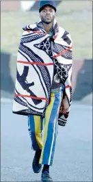  ??  ?? TRIBAL: Basotho-inspired AK-47 knitted blanket wrapped over striped, tailored pants and warrior headphone.