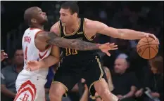  ??  ?? Houston Rockets forward PJ Tucker (left) reaches for the ball held by Los Angeles Lakers center Brook Lopez during the first half of an NBA basketball game on Tuesday, in Los Angeles. AP PHOTO/MARK J. TERRILL
