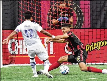  ?? HYOSUB SHIN / HYOSUB.SHIN@AJC.COM ?? Orlando City forward Nani (17) takes a shot against Atlanta United defender Miles Robinson on goal during the second half of their match Saturday at Mercedes-Benz Stadium.