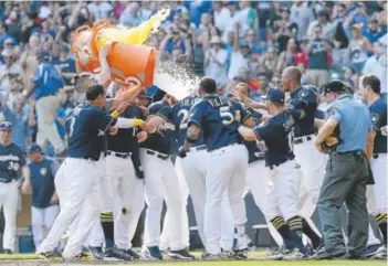  ?? Dylan Buell, Getty Images ?? The Brewers celebrate Saturday after Travis Shaw hit a two-run, walk-off homer to beat the Chicago Cubs 4-3 in 10 innings at Miller Park in Milwaukee. Shaw has 31 home runs.