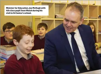  ??  ?? Minister for Education Joe McHugh with 4th class pupil Sean Walsh during his visit to St Canice’s school.