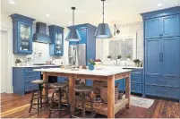  ??  ?? NOW: The sleek, quartz backsplash blends a modern esthetic with the rustic, open island and reclaimed wood flooring.