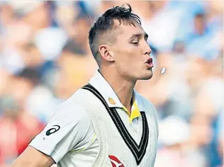  ??  ?? Bad habit: Marnus Labuschagn­e angrily spits out his chewing gum after losing his wicket in the fourth Test at Old Trafford