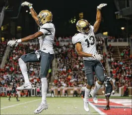  ?? MICHAEL REAVES / GETTY IMAGES ?? Tre’Quan Smith (left) celebrates a touchdown with Gabriel Davis in the weathersho­rtened 51-23 victory over Cincinnati.