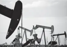  ?? Charlie Riedel / Associated Press ?? Pump jacks work in a field near Lovington, N.M.