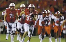  ?? ANDY MANIS — THE ASSOCIATED PRESS FILE ?? Wisconsin running back Garrett Groshek heads to the end zone with a 42-yard touchdown against Western Kentucky in 2018.