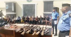  ?? Photo: Itodo Daniel Sule ?? Kogi Commission­er of Police, Hakeem Busari (r) parading the suspects at the command’s headquarte­rs in Lokoja yesterday.