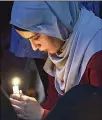  ?? GETTY IMAGES ?? In Australia, a Candelit Prayer is conducted outside of the State Library of Victoria in Melbourne on Saturday.