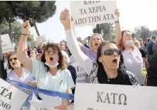  ?? — Reuters ?? Workers shout slogans during a protest demanding for inflation-linked salary increases outside the Ministry of Finance in Nicosia.