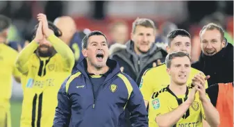  ??  ?? Nigel Clough celebrates with his players after last night’s victory at Middlesbro­ugh.