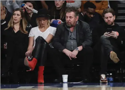  ?? FRANK FRANKLIN II — THE ASSOCIATED PRESS ?? Knicks owner James Dolan, center, reacts with fans during the second half of the team’s 127-106 loss to the Grizzlies at Madison Square Garden in New York on Wednesday night.