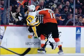  ?? MATT SLOCUM - THE ASSOCIATED PRESS ?? Garnet Hathaway, right, collides with Pittsburgh Penguins’ Marcus Pettersson during the second period Monday.