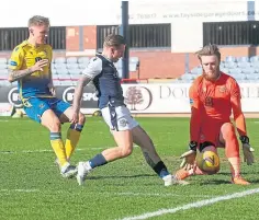  ??  ?? Zander Clark stops Dundee striker Jason Cummings.