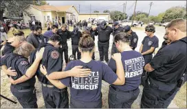  ?? ERIC GAY / AP ?? First responders join in prayer following a Veterans Day event Saturday near the Sutherland Springs First Baptist Church, in Sutherland Springs, Texas. A man opened fire inside the church Nov. 5, killing more than two dozen.