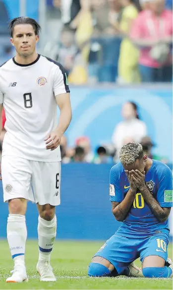  ?? THE ASSOCIATED PRESS ?? Neymar falls to his knees and appears to weep following Brazil’s 2-0 win over Costa Rica on Friday at the World Cup. His over-the-top displays of emotion are turning fans and officials against him.