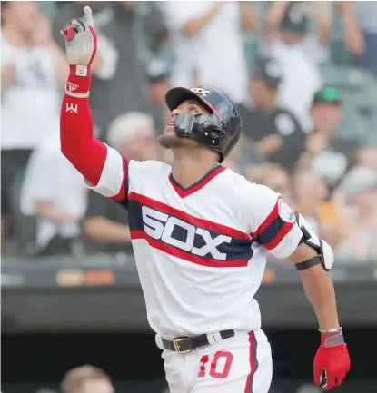  ?? AP (ABOVE), GETTY IMAGES ?? Yoan Moncada (above) celebrates his home run Sunday in support of Lucas Giolito (left), who pitched 6„ scoreless innings.