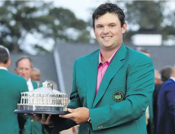  ?? DAVID CANNON/GETTY IMAGES ?? Patrick Reed celebrates with his trophy during the green jacket ceremony after winning the 2018 Masters by one stroke on Sunday in Augusta, Ga.