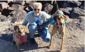  ?? AP ?? Leksa Pravdic goes on a hike in Santa Fe, New Mexico, with her dogs Scout (left) and Pluto during a road trip.