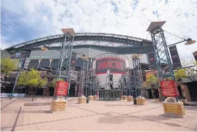  ?? ROSS. D. FRANKLIN/ASSOCIATED PRESS ?? The main entrance to Chase Field in Phoenix was devoid of activity on March 26, the week major league baseball was supposed to get going. Bringing each of the 30 teams to Arizona is one of the least risky, but also least popular plans to reopen.