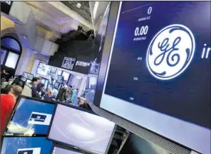  ?? AP/RICHARD DREW ?? The General Electric logo is shown on a screen Monday on the floor of the New York Stock Exchange. GE announced Monday that it plans to merge its oil and gas division with oilfield services company Baker Hughes.