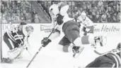  ?? JAY LAPRETE/AP ?? Florida’s Vincent Trocheck, center, jumps over Columbus Blue Jackets’ Zach Werenski, right, to shoot the puck against Sergei Bobrovsky.