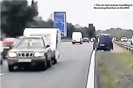  ?? Handout ?? &gt; The car and caravan travelling in the wrong direction on the M40