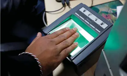  ??  ?? A woman goes through the process of finger-scanning for the Aadhaar system at a registrati­on centre in Delhi. Photograph: Saumya Khandelwal/Reuters