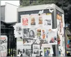  ?? Picture: REUTERS ?? AFTERMATH: Damage to Grenfell Tower is seen, behind missing person posters stuck to a telephone box, following the catastroph­ic fire, in north Kensington, London, Britain