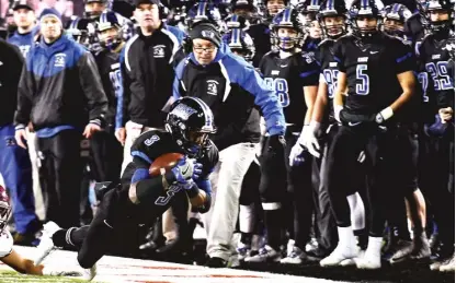  ?? | WORSOM ROBINSON/ FOR THE SUN- TIMES ?? Lincoln- Way East running back AJ Henning dives for a first down Saturday at Huskie Stadium.